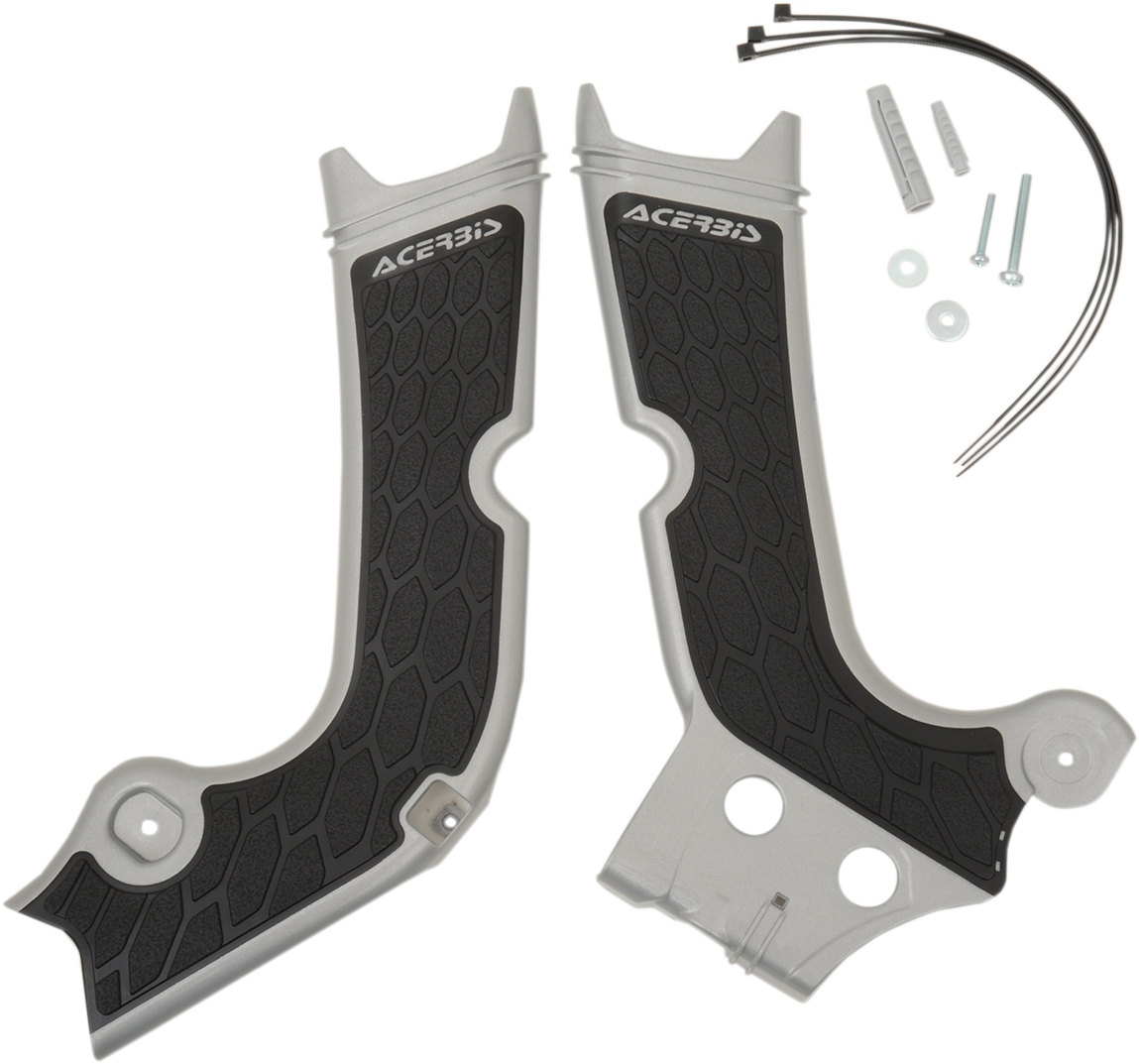 A close-up of Acerbis X-Grip frame guards in silver and black, designed to protect motorcycle frames, mounted on a bike.
