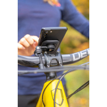 Bill's Exhausts SP CONNECT phone mount securely attached to a motorcycle handlebar, showcasing a sleek, durable design.