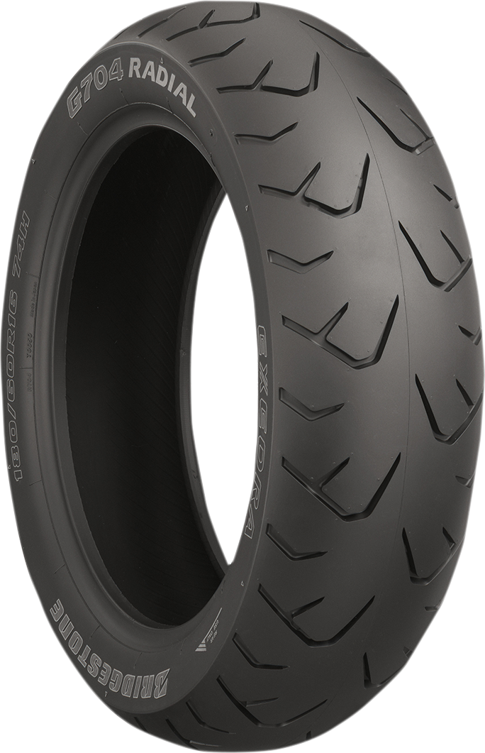 Bridgestone Exedra G704 rear motorcycle tire 180/60R16 with 74H load index and model 70627, showing tread pattern and sidewall details.