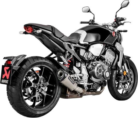 AKRAPOVIC titanium muffler for Honda CB1000R motorcycle, showing sleek exhaust design and branding on the part.