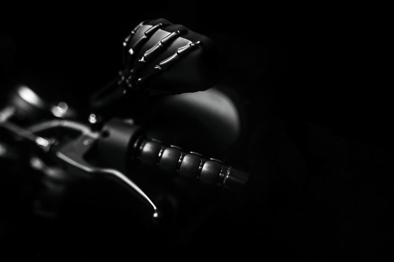 Kuryakyn Skeleton Hand Mirrors in black for powersports vehicles, showing detailed skeletal design on motorcycle mirror.