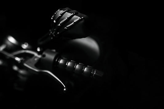Kuryakyn Skeleton Hand Mirrors in black for powersports vehicles, showing detailed skeletal design on motorcycle mirror.