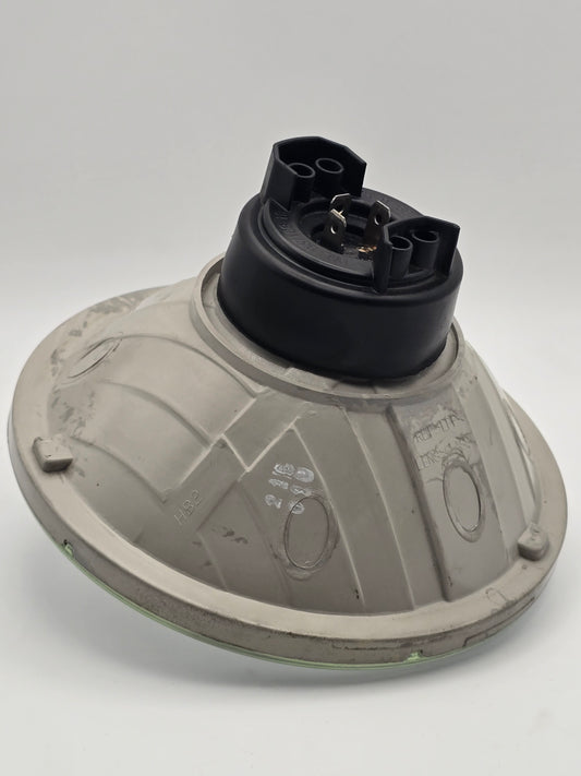 Used Harley-Davidson 7-inch halogen headlight HD 68390-05 with chrome housing and clear lens for motorcycle lighting.