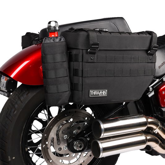 Black THRASHIN SUPPLY CO. holster Molle bottle holder for 12" x 3.5" bottles, featuring durable construction and adjustable straps.