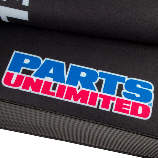 Large PARTS UNLIMITED absorbent pit pad with logo, designed for shop and pit area protection, shown in the image.
