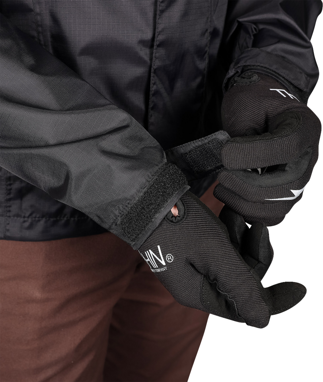 Black THRASHIN SUPPLY CO. Mission WP rain jacket, medium size, showing waterproof fabric and front zipper details.