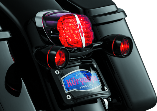 Kuryakyn Deep Dish Turn Signal Bezels with Red Lenses for Harley-Davidson motorcycles, featuring chrome finish and round design.