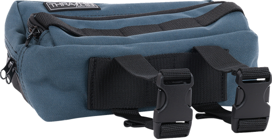 Blue handlebar bag from THRASHIN SUPPLY CO., featuring a compact design with adjustable straps for bike storage.