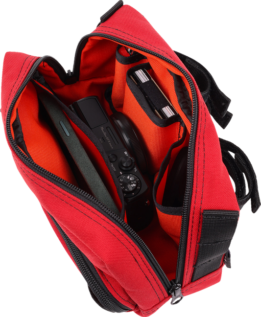 Red handlebar bag by THRASHIN SUPPLY CO. with adjustable straps and zippered compartments for bike storage.