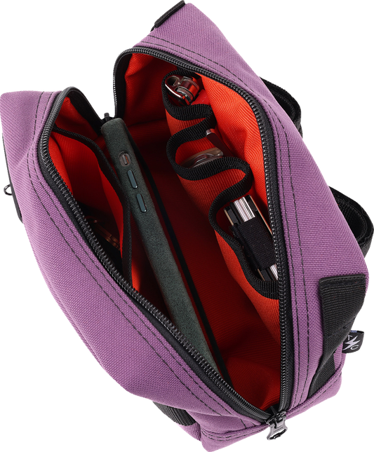 Purple THRASHIN SUPPLY CO. handlebar bag with adjustable straps, designed for bike handlebars and outdoor use.