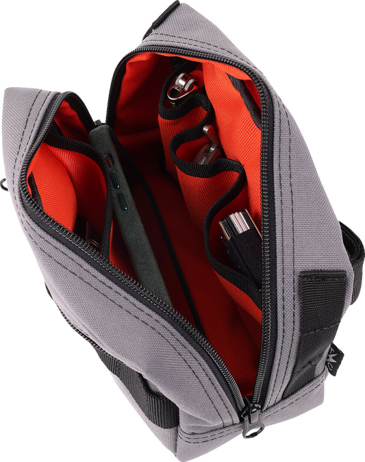 Gray handlebar bag by THRASHIN SUPPLY CO. with adjustable straps and zipper closure, designed for easy bike storage.
