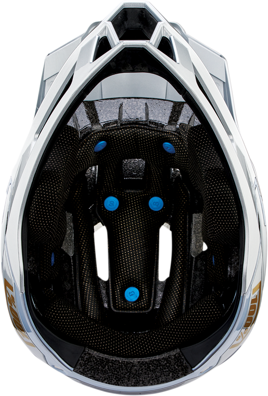 Silver 100% Trajecta bicycle helmet with Fidlock closure in large size, shown from the front with adjustable straps.