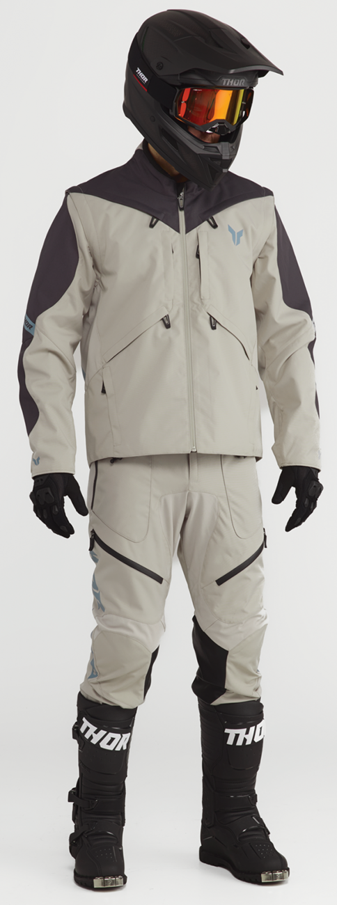 THOR Terrain in-the-boot pants in sand color, US size 34, with rugged fabric and reinforced knee panels for durability.