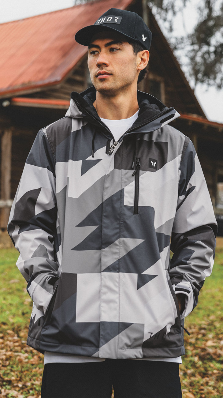 Gray and black camo THOR Brave Tour motorcycle jacket, insulated and waterproof, in size XL, with protective features.