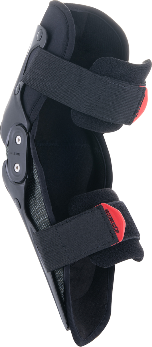 Alpinestars youth SX-1 knee protectors in black and red, small/medium size, showing padded protective gear for motocross or riding.