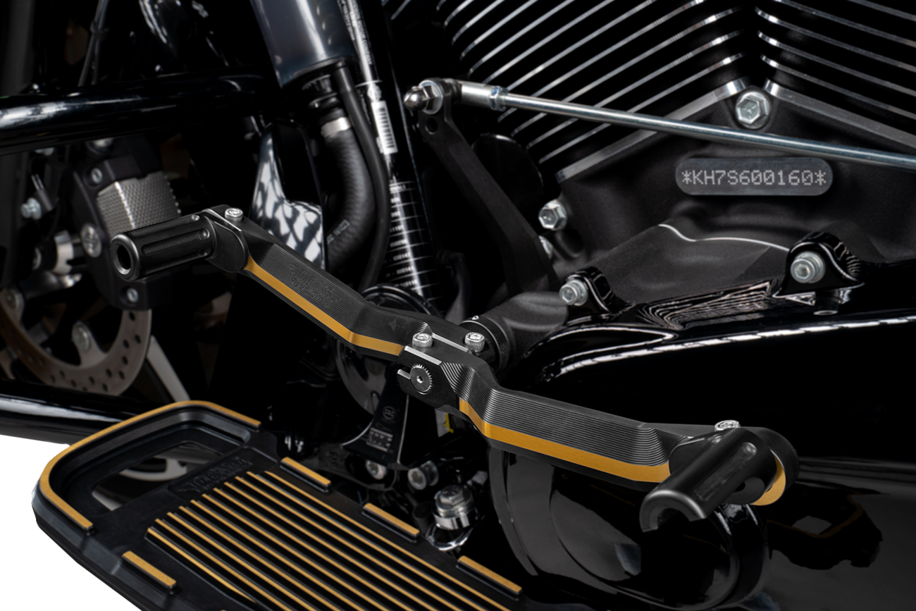 Black and gold adjustable motorcycle heel and toe shifter controls by Drag Specialties for custom bike shifting.