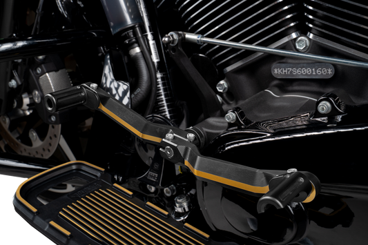 Black and gold adjustable motorcycle heel and toe shifter controls by Drag Specialties for custom bike shifting.