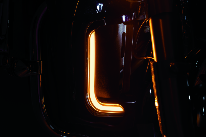 Kuryakyn Tracer LED fairing lower accents in chrome on a Harley Davidson touring motorcycle, showcasing sleek, illuminated design.
