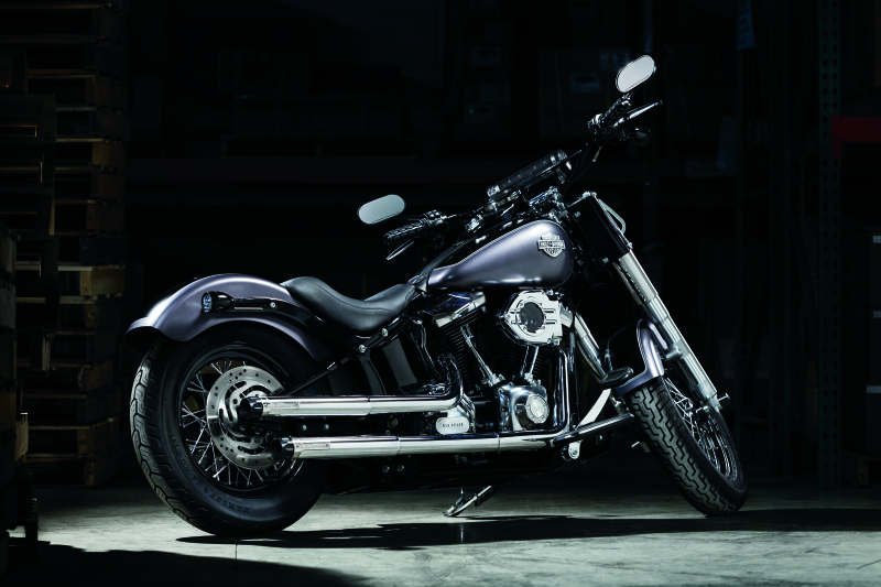 Kuryakyn satin black front axle nut caps for Harley Davidson Touring models, designed to protect and enhance wheel appearance.