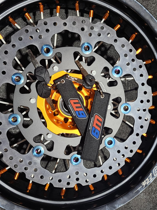 Warp9Racing fabric key chain featuring the Warp 9 Racing logo and vibrant design, attached to a metal keyring.