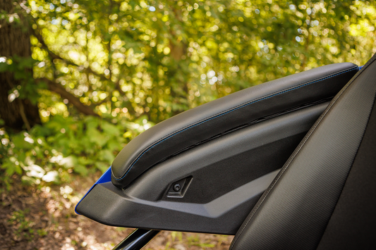 Black SHOW CHROME Kaliber Armrest Pads with blue stitching for Slingshot 2015-2022 engine, featuring durable design and detailed stitching.