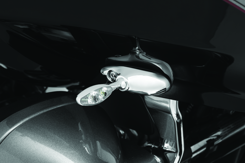 Kuryakyn front turn signal mounts for Harley Davidson Road Glide models, showing black metal brackets attached to motorcycle frame.