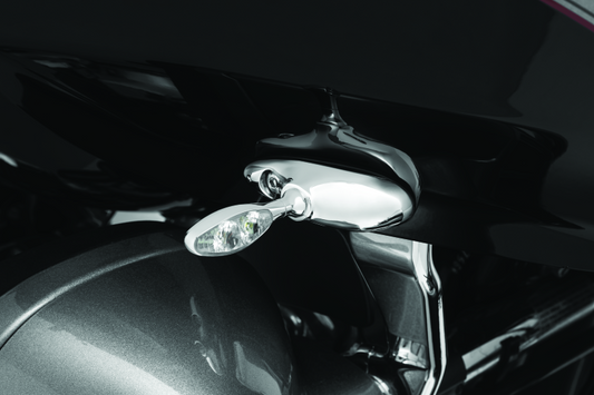 Kuryakyn front turn signal mounts for Harley Davidson Road Glide models, showing black metal brackets attached to motorcycle frame.