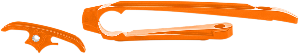 Orange ACERBIS Chain Slider for KTM motorcycle, shown mounted on the bike's body, designed to protect the chain and swingarm.