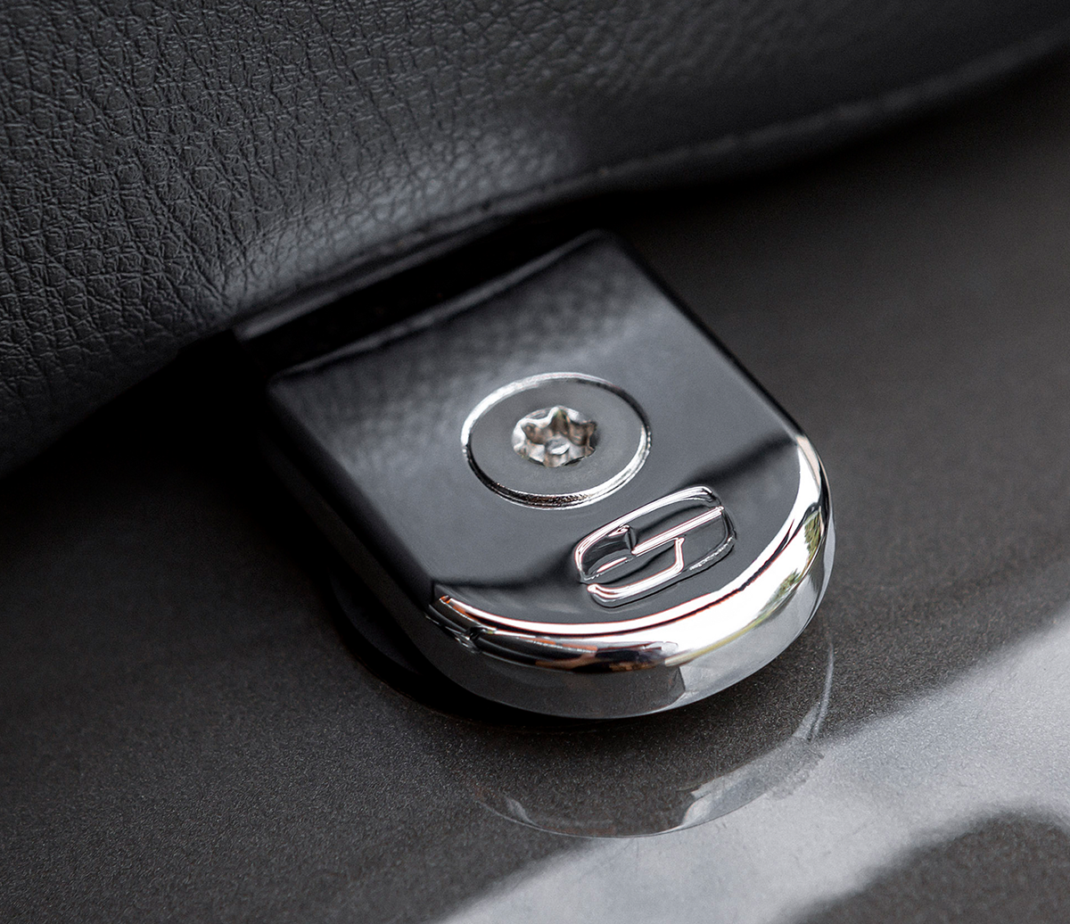 Chrome SADDLEMEN Security Seat Screw for motorcycle seats, designed for secure fastening and sleek appearance.