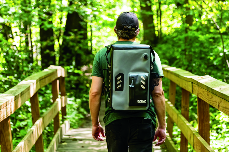 Kuryakyn Torke 25L dry motorcycle backpack with reflective logos, fully waterproof design, adjustable straps, and versatile storage compartments.