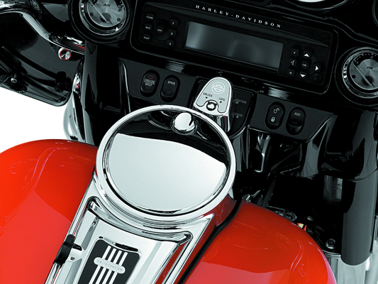 Kuryakyn chrome push-button fuel door latch for Harley-Davidson touring bikes, showing the latch and surrounding chrome detail.