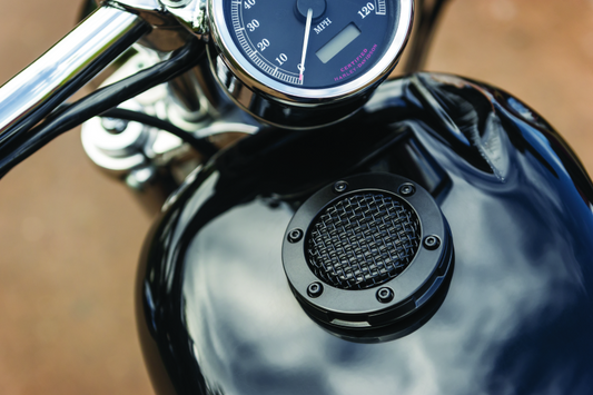 Kuryakyn Mesh Vented Gas Cap for Harley Davidson Touring models, featuring a sleek mesh design and chrome finish.