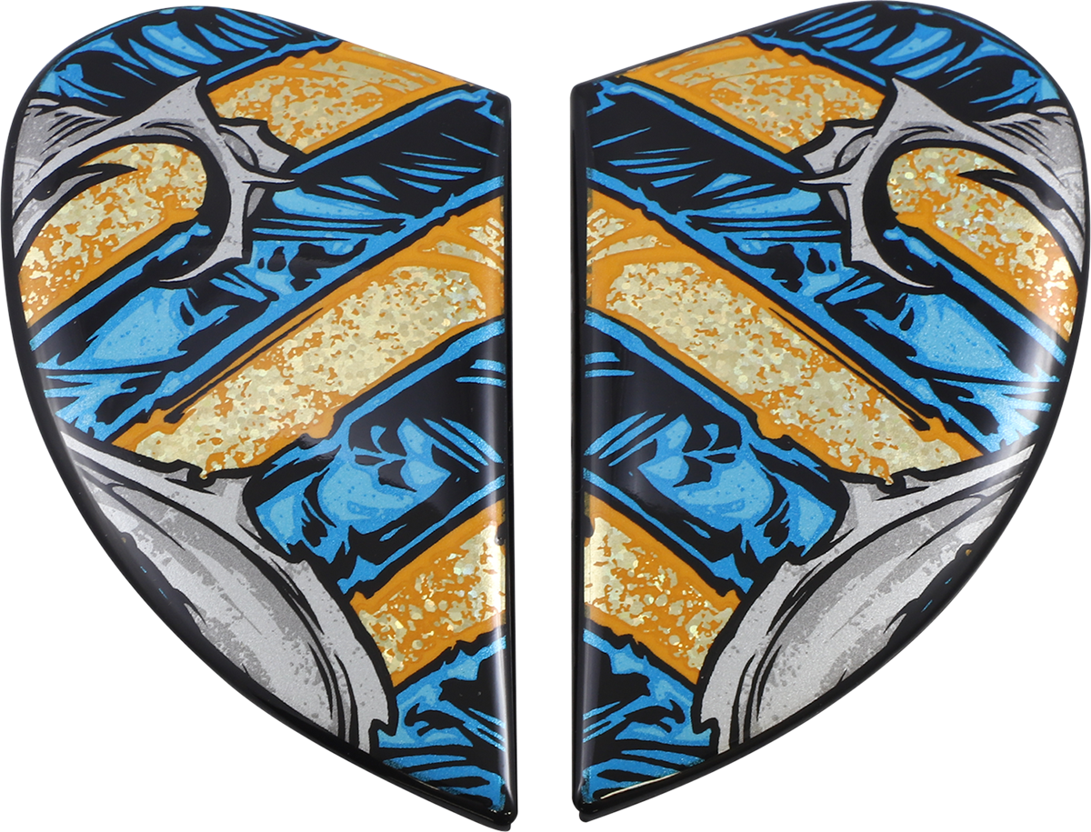 Gold ICON Airform™ Pharaoh side plates for helmets, showcasing detailed design and branding on a sleek helmet accessory.