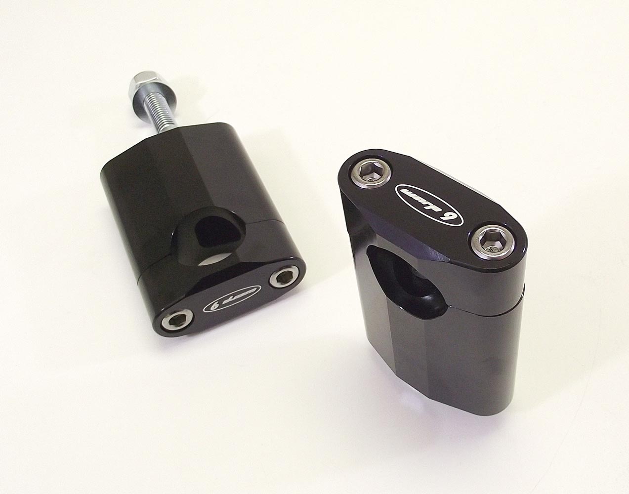 Warp9Racing Handle Bar Risers for Suzuki motorcycles, shown installed on bike handlebars, providing increased height and comfort.