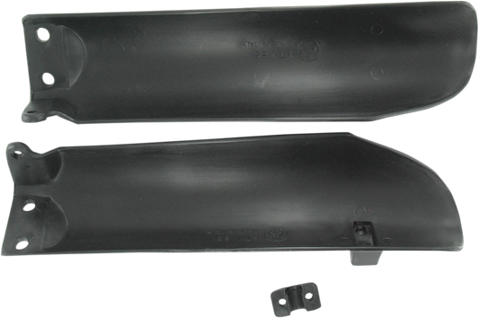 Black Acerbis lower fork covers for inverted motorcycle forks, shown on a bike's front suspension.