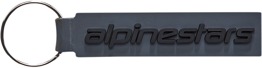 Alpinestars linear key fob with protective gear design, featuring black and gray accents, attached to a keychain.