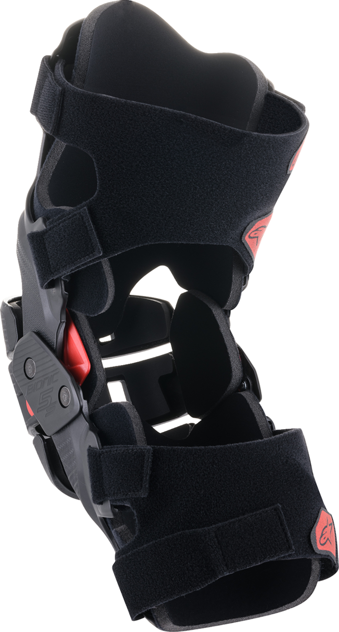 Alpinestars Youth Bionic 5S knee braces in black and red, designed for protection and support during motocross or biking.