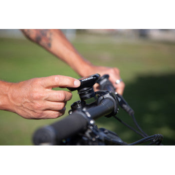 Bill's Exhausts SP CONNECT phone mount attached to a motorcycle handlebar, securely holding a smartphone for easy access.