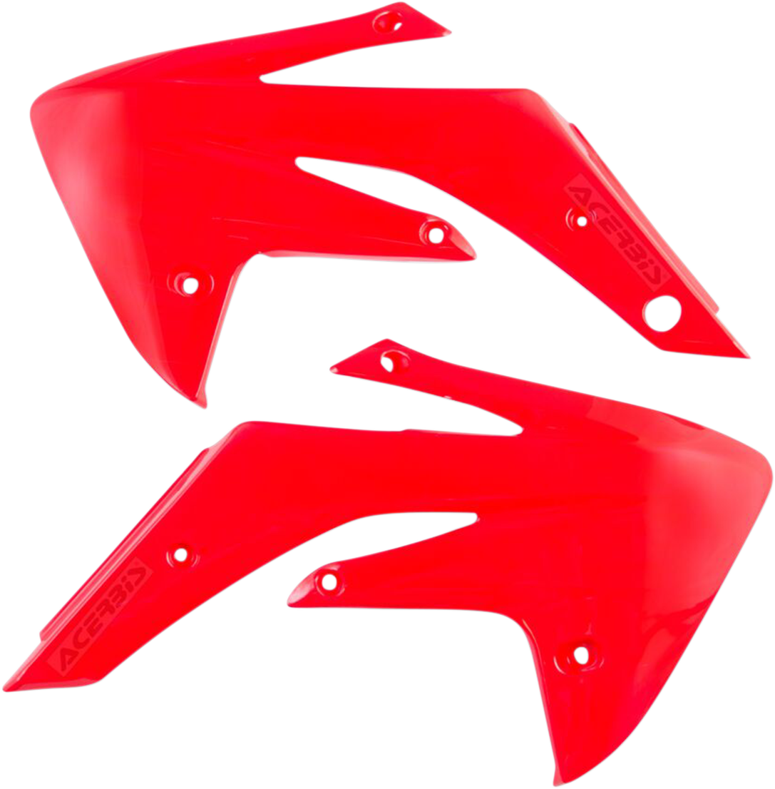 Red Acerbis radiator shrouds for body protection, designed for off-road or motocross bikes, with visible mounting points and aerodynamic shape.