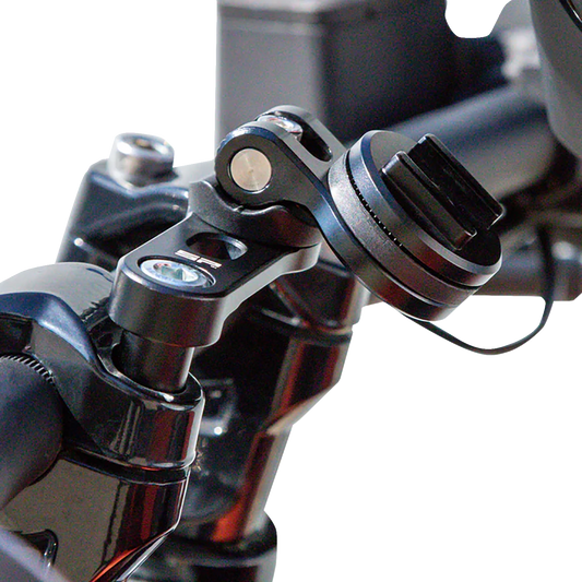 Black SP CONNECT Pro phone mount on handlebar clamp, securely holding a smartphone for bike or motorcycle use.