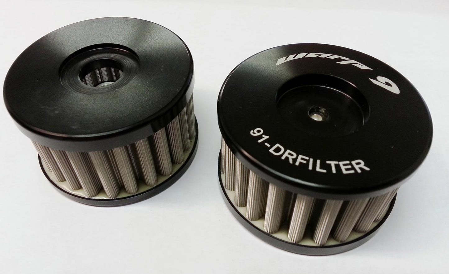 Suzuki DR650 oil filter by Warp9Racing shown from front and back angles, designed for effective engine oil filtration.