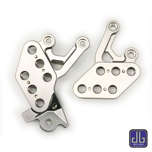 Silver CNC aluminum foot peg drop bracket for Surron LBX electric bike by eDirtyBike, designed for durability and performance.