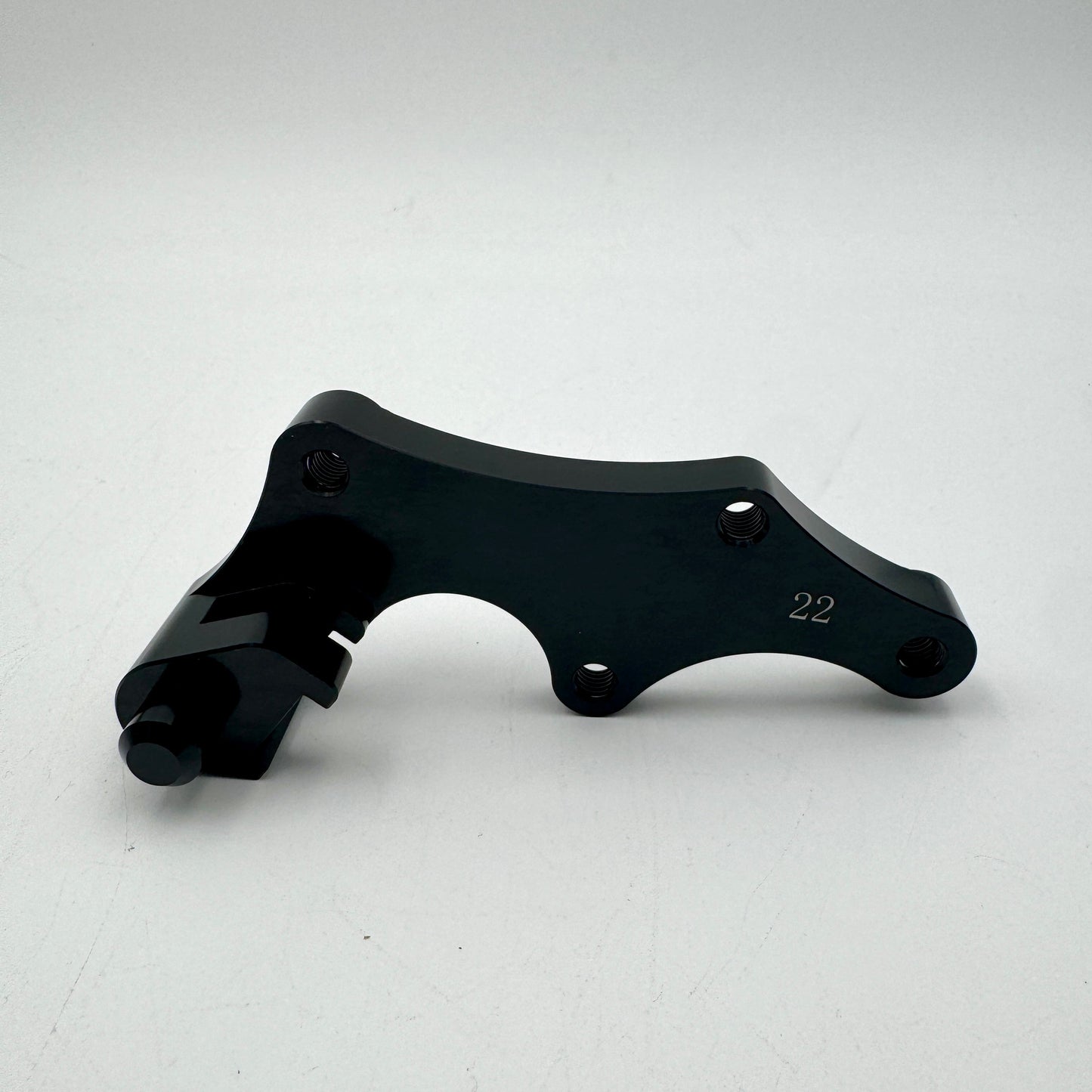Warp9Racing Bracket 22 BETA with mounting hardware, shown in metallic finish, designed for automotive or racing applications.