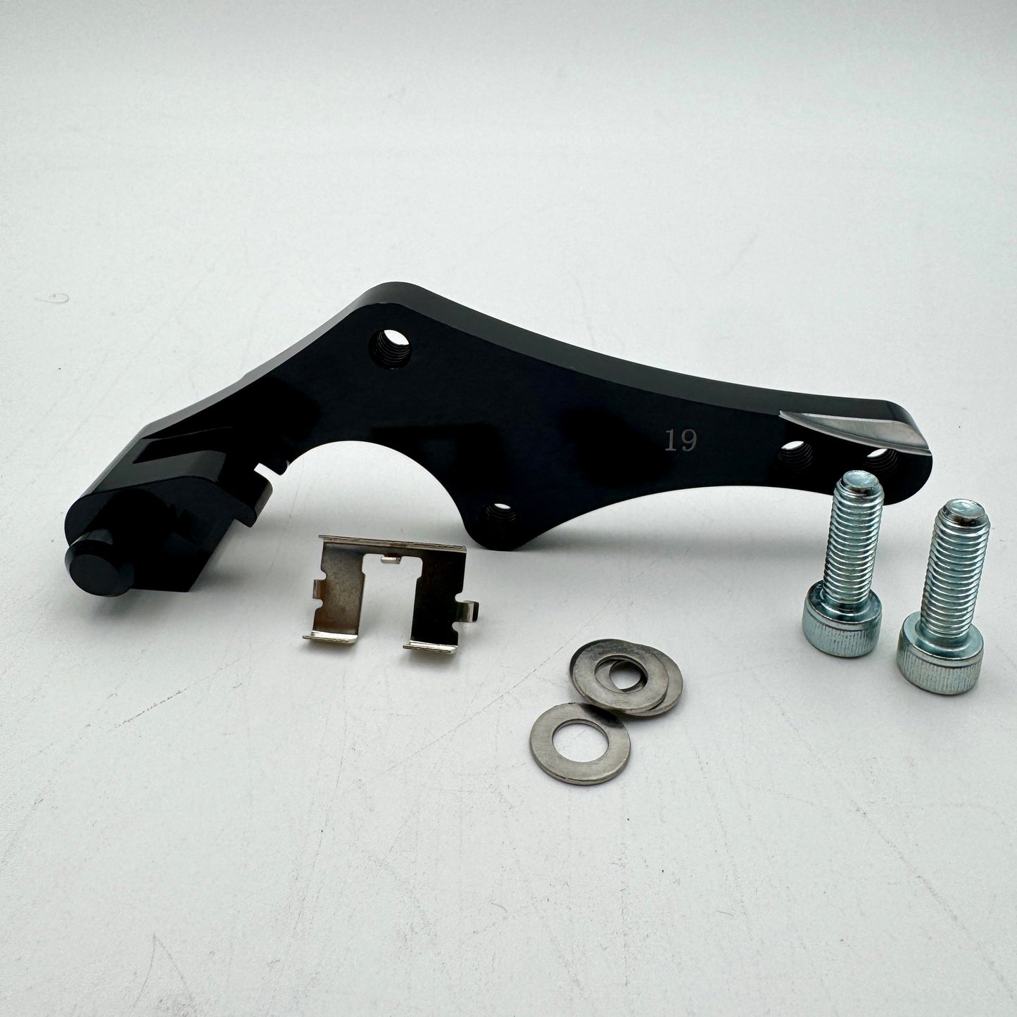 Warp9Racing bracket for KTM, Husqvarna, Gas Gas, Husaberg, Stark, and Triumph motorcycles, shown in black metal.