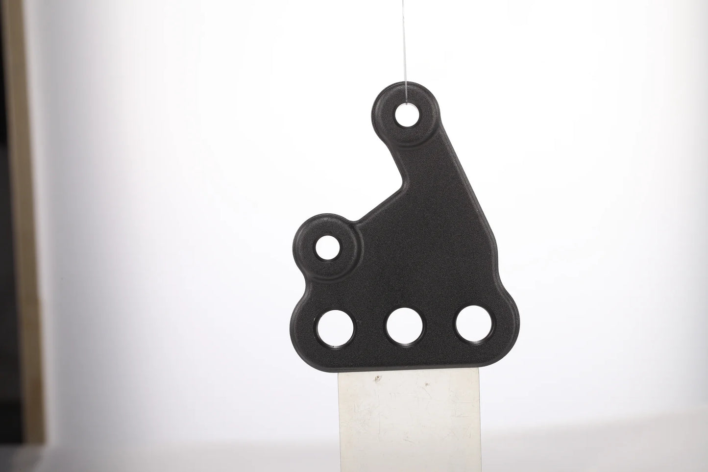 E Ride Pro left footpeg mounting bracket assembly for motorcycle, showing the sturdy metal bracket with mounting points.