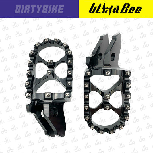 Black aluminum CNC foot pegs for Sur-Ron Ultra Bee eDirtyBike, heavy-duty motorcycle foot pegs for off-road riding.