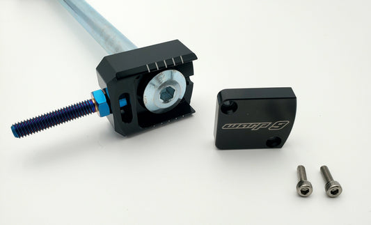 Warp 9 Racing Lockdown Axle Blocks for Sur-Ron Light Bee, titanium captive adjustment, with steel construction visible in the image.