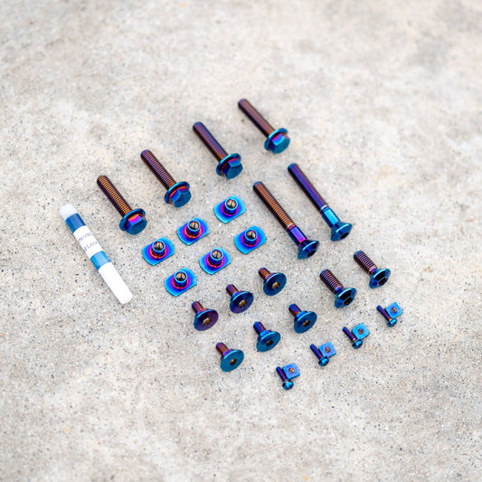 Cycra Titanium Bolt Kit by Warp9Racing featuring lightweight, durable titanium bolts on a black background.