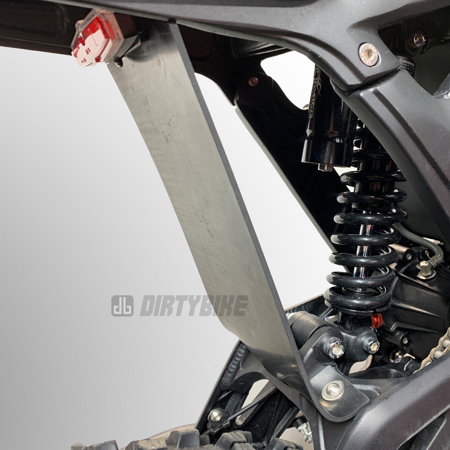 eDirtyBike Talaria Sting mud guard and shock protector mounted on bike, designed to shield from dirt and debris during rides.
