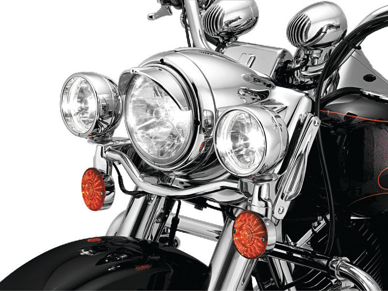 Kuryakyn 7-inch headlight visor for Harley-Davidson motorcycles, black metal shield with mounting hardware visible